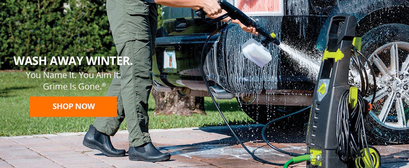 Person using a Sun Joe Electric Pressure Washer with a foam cannon attachment to clean a car. Wash away winter: You name it, you aim it, grime is gone.