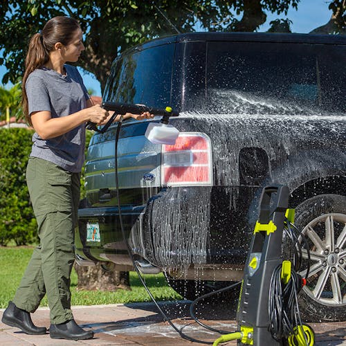 Sun Joe 13-amp 2080 PSI Electric Pressure Washer being used to clean an SUV car.