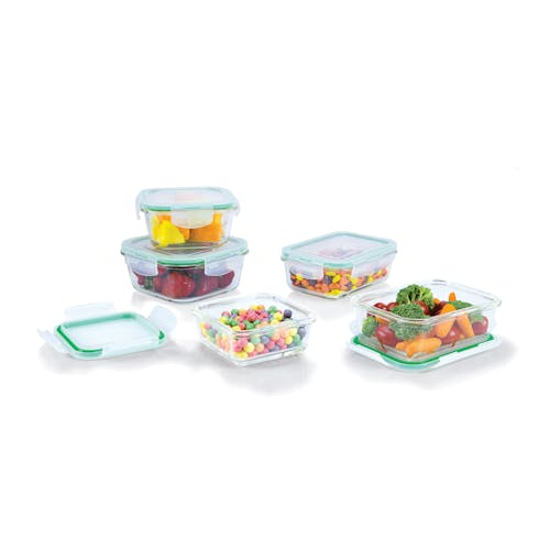 EatNeat 10-piece set of 5 square glass storage bowls with airtight locking lids containing different fruits and candies with the lids on two of them taken off.