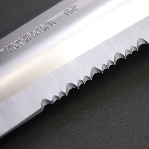 Close-up of the serrations on the blade of the Niasku Miyamatou 7.5-inch Japanese Stainless Steel Knife.