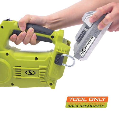 Person inserting a battery onto the back of the Sun Joe 24-Volt Cordless 10-inch chainsaw. Battery and charger sold separately.