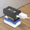 Sun Joe 24-Volt Cordless Portable Powered Inverter with a 4.0-Ah lithium battery attached and chargers plugged in.