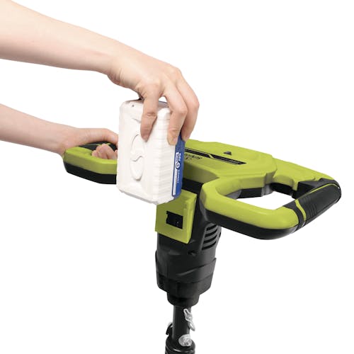 Person inserting a 4.0-Ah lithium-ion battery onto the Sun Joe 24-Volt 30-inch Cordless Earth Auger.