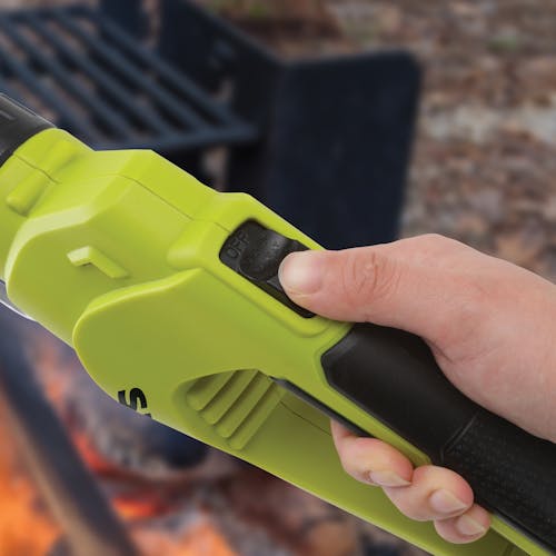 Person turning on the Sun Joe 24-Volt cordless electric fire starter and barbeque lighter.