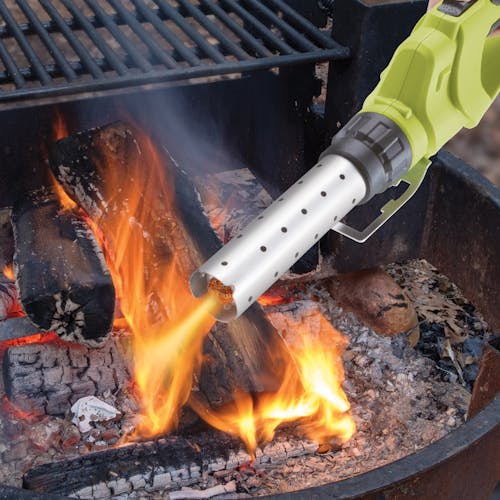 Sun Joe 24-Volt cordless electric fire starter and barbeque lighter being used to light a grill.
