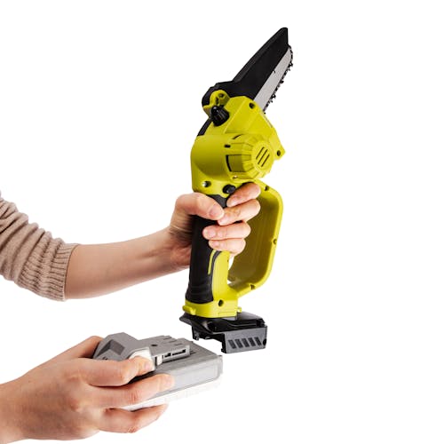 Person putting a 2.0-Ah lithium-ion battery onto the Rear-angled view of the Sun Joe 24-volt cordless Cordless Telescoping Pole Pruning Saw Kit.