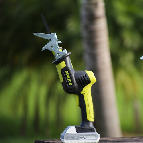 Side view of the Sun Joe 24-volt Cordless All-Purpose Reciprocating Saw Kit outside.