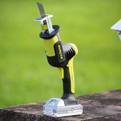 Angled view of the Sun Joe 24-volt Cordless All-Purpose Reciprocating Saw Kit with the metal cutting blade.