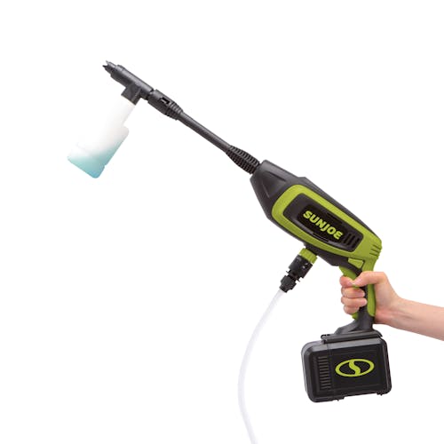 Person holding the Sun Joe 24-Volt Cordless Power Cleaner white a foam cannon attached to it.