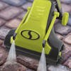 Sun Joe 24-volt cordless Cordless Surface & Patio Cleaner Kit being used to spray and brush paving stones.