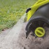Sun Joe 24-volt cordless Cordless Surface & Patio Cleaner Kit being used to spray and clean a driveway.