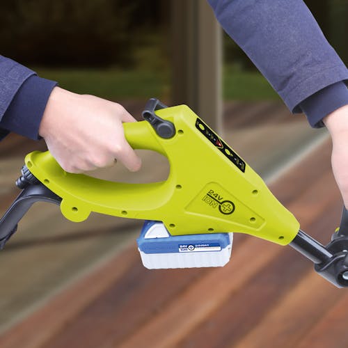 Close up of the handle on the Sun Joe 24-volt cordless Cordless Surface & Patio Cleaner Kit with a 4.0-Ah lithium-ion battery attached.