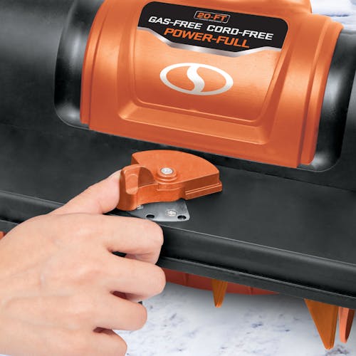 Person adjusting the angle on the Snow Joe 24-volt cordless 12-inch snow shovel kit in orange.