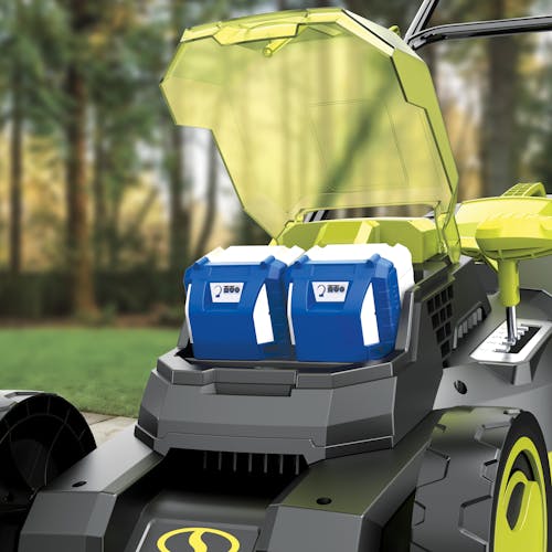 Close-up of the battery compartment on the Sun Joe 48-volt cordless brushless 16-inch lawn mower kit showing two 4.0-Ah lithium-ion batteries installed.