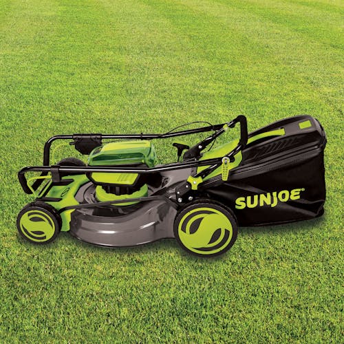 Side view of the Sun Joe 48-volt cordless 21-inch lawn mower kit on grass.