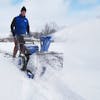 man blowing snow using snow joe cordless 96 volt snowblower
