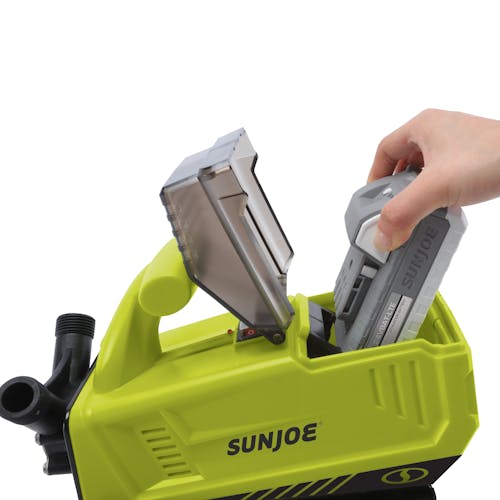 Person inserting a 2.0-Ah lithium-ion battery into the Sun Joe 24-volt Cordless 5.0-GPM Transfer Pump.