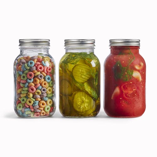 Three EatNeat 32-ounce Quart Glass Canning Jars with airtight metal lids filled with different foods.