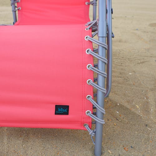 Close-up of the frame and bungees on the coral beach recliner.