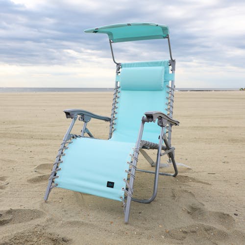 Sea Glass beach recliner with canopy on the sand.