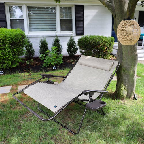 45-inch 2-Person Sand Gravity Free Recliner reclined under a tree.
