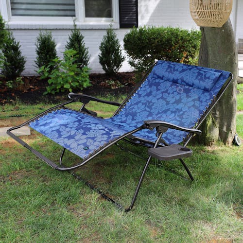 45-inch 2-Person Blue Flower Gravity Free Recliner reclined under a tree.