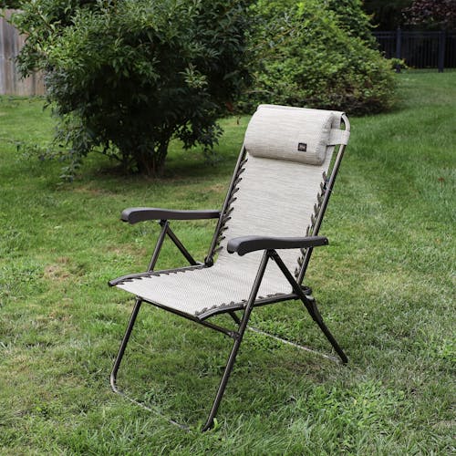 Angled view of the 26-inch Sand Reclining Sling Chair on a lawn.