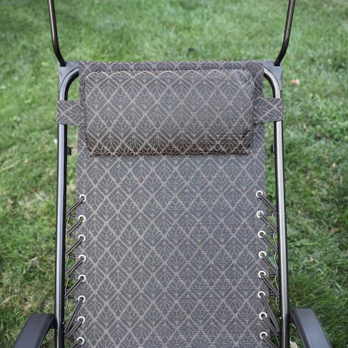 Close-up of the headrest on the 26-inch brown leaves gravity free chair.