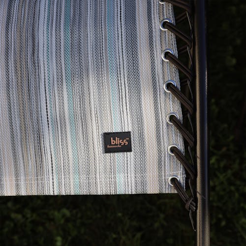 Close-up of the bungees and Bliss Hammocks logo on the 26-inch casual stripe gravity free chair.