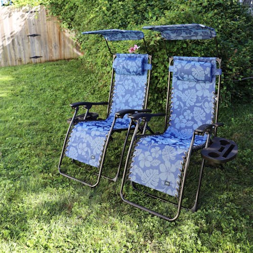 Set of 2 26-inch blue flower gravity free chairs placed on a lawn.