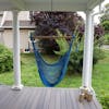 Bliss Hammocks 40-inch Light Blue Island Rope Hammock Chair hanging on a front porch.