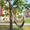 Bliss Hammocks 40-inch Multi-color Island Rope Hammock Chair hanging from a tree.