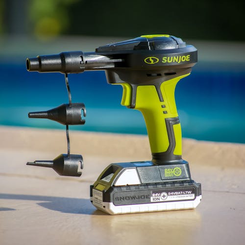 Sun Joe 24-Volt Cordless High-Volume Inflator with nozzle attachments and a 1.3-Ah battery attached.