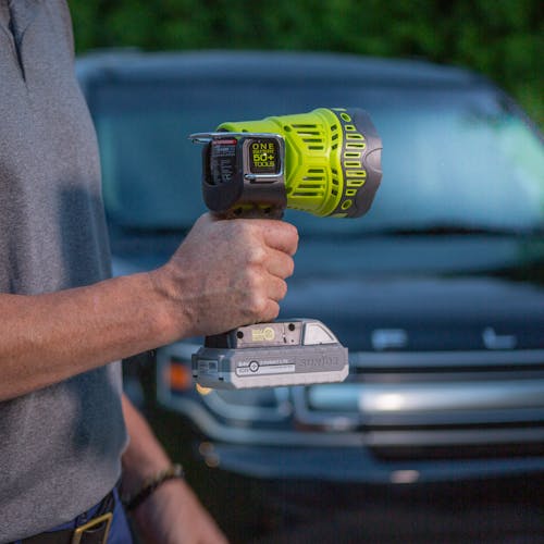 Man using the Sun Joe 24-Volt Cordless Flashlight/Flood Light/Spot Light to see outside in the dark.