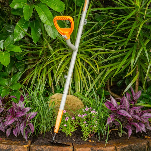 ErgieSystems 54-inch Shank Pattern Garden Hoe with 6.25-inch blade next to plants.