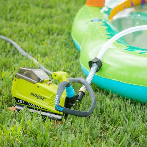 Sun Joe 24-volt Cordless 5.0-GPM Transfer Pump transferring water from a blow up pool.