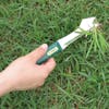 Nisaku Tayouto Nekiri 4.25-inch Stainless Steel Multi Weeder being used to pull weeds out of a lawn.
