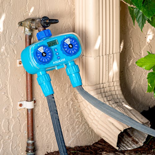 Aqua Joe 2-Zone Electronic Water Timer connected to a faucet and 2 garden hoses.