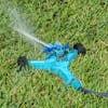 Aqua Joe 10-inch wheeled base Indestructible Zinc Impulse 360 Degree Sprinkler watering a lawn.