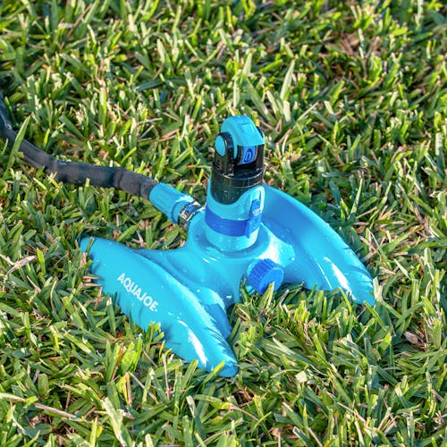 Aqua Joe 4-Pattern Turbo Drive 360 Degree Sprinkler sitting in grass.