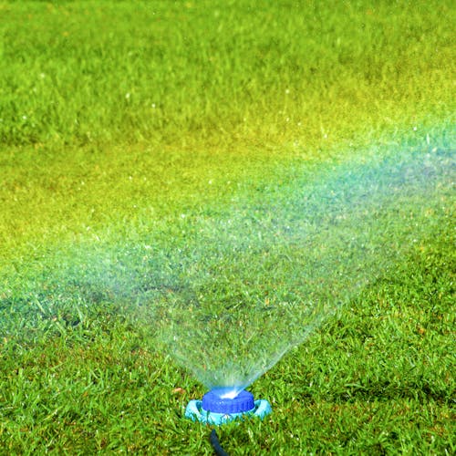 Mist setting on the Aqua Joe Indestructible Metal Turret Sprinkler making a rainbow.
