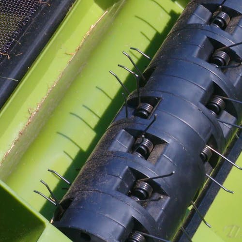 Close-up of the dethatching cylinder on the Sun Joe 12-amp 13-inch Electric Lawn Dethatcher with Collection Bag.