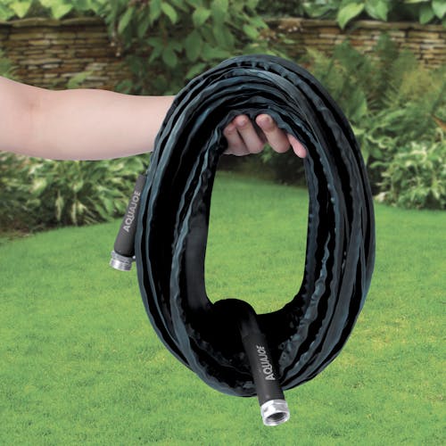 Person holding the Aqua Joe 75-foot non-expanding black fiberjacket hose.