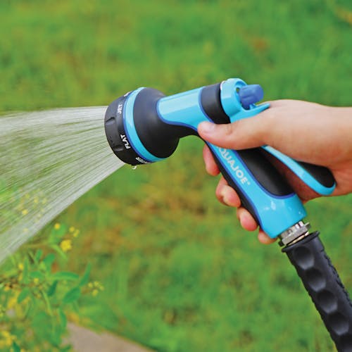 Aqua Joe Indestructible Series Heavy-Duty Metal Trigger Nozzle with 7 spray patterns watering plants.