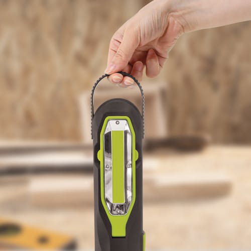 Person holding the handle on the top of the Auto Joe Cordless 12-Volt High Performance Vehicle Jump Starter.