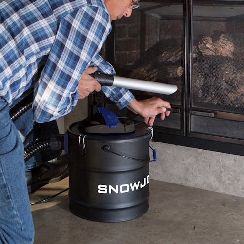 Snow Joe 5-amp 4.8 Gallon Ash Vacuum being used to clean an indoor fierplace.