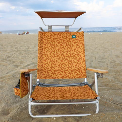 Front view of the folding amber leaf beach chair with canopy on the beach.