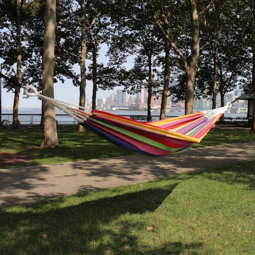 40-inch mardi gras hammock hung outside between two trees.