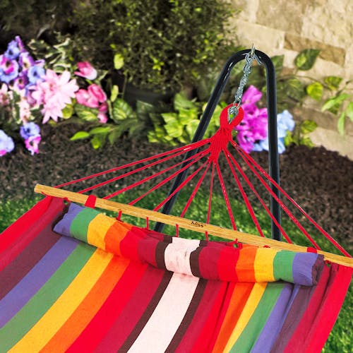 Close-up of the Bliss Hammocks 48-inch Wide Tequila Sunrise Caribbean Hammock hanging from a hammock stand.