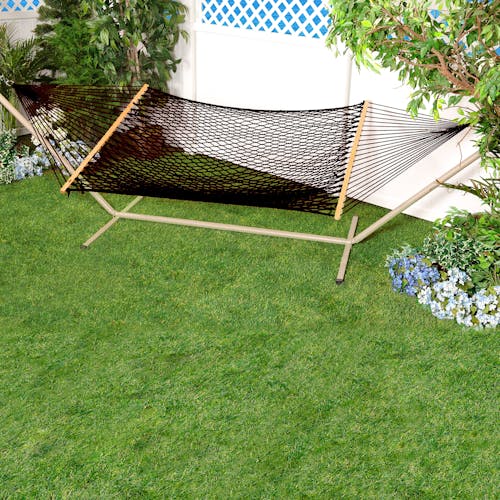 Bliss Hammocks 60-inch Wide Black Cotton Rope Hammock secured to a stand in a backyard.